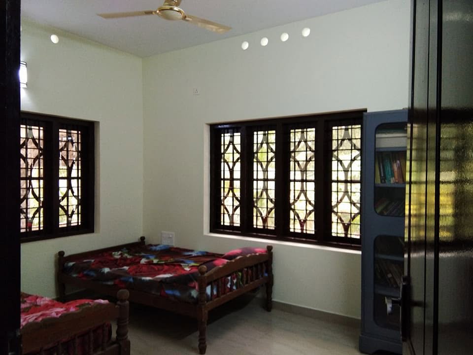 Completed bedroom with wooden windows and natural daylight