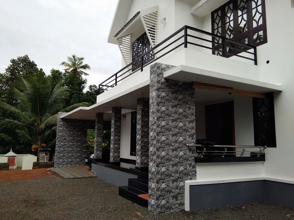 Close view of the completed home's verandah and stone-clad columns