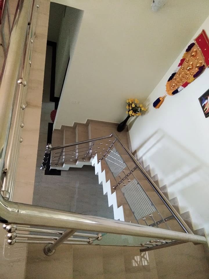 Top view of the completed staircase with polished metal railings